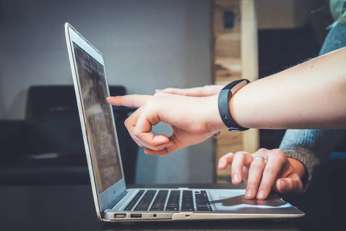 Colleague pointing at a laptop screen during a support session