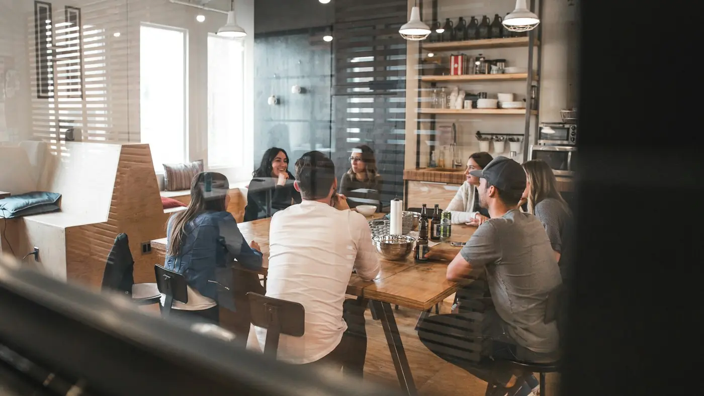 Colleagues in discussion around a table in a modern office